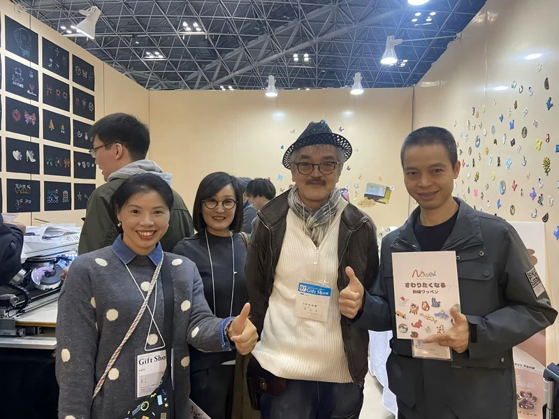 Buyers at the Tokyo Gift Show looking through patch and keychain samples