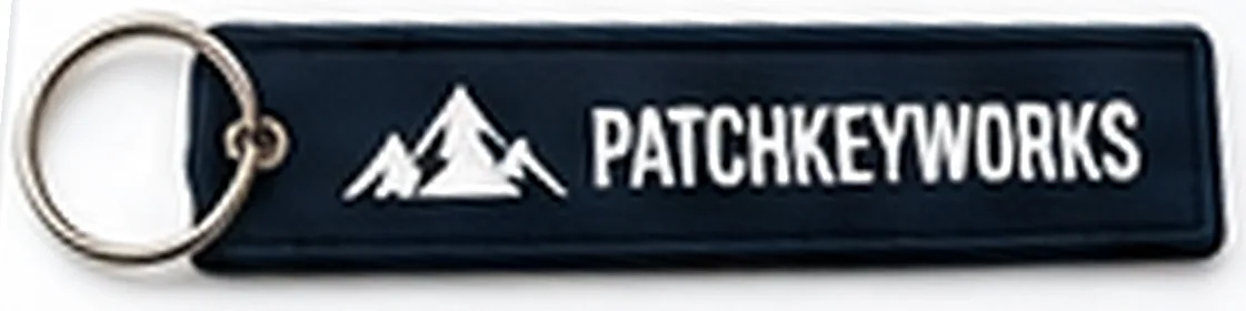 Woven key tag with the PatchKey Works logo and mountain artwork