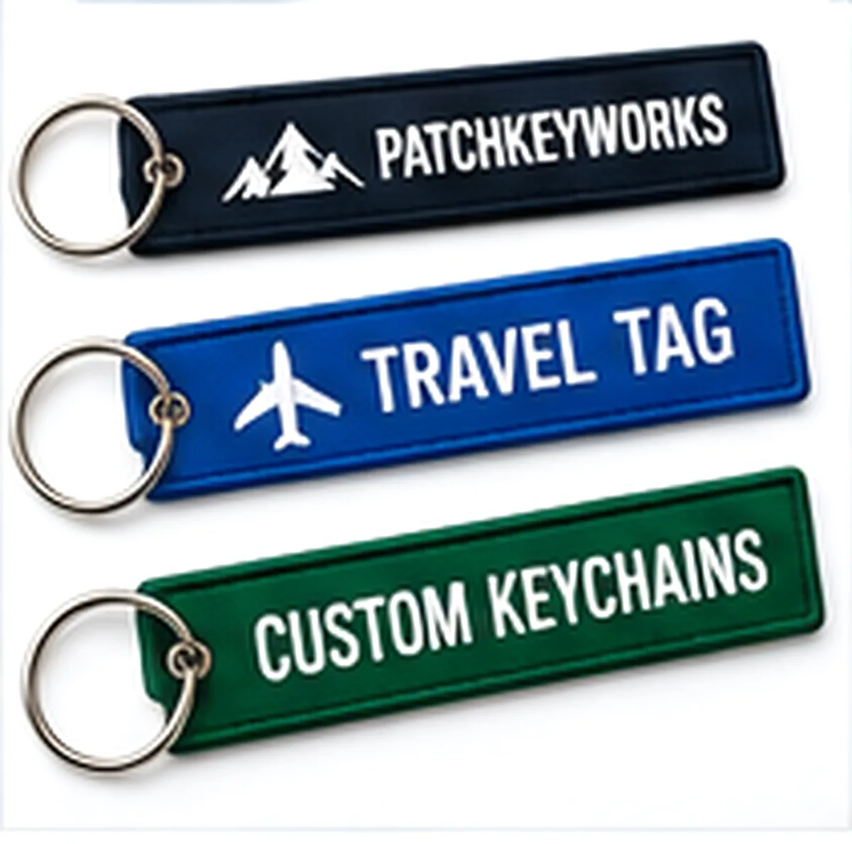 Three woven key tags with rings, laid out together