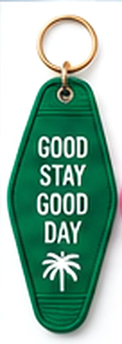 Green hotel key tag reading Good Stay Good Day