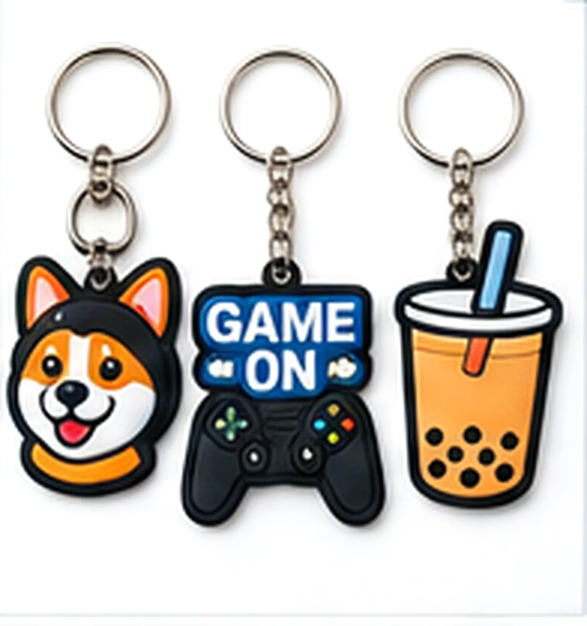 Three PVC keychains: a Shiba Inu, a Game On controller and a bubble tea cup