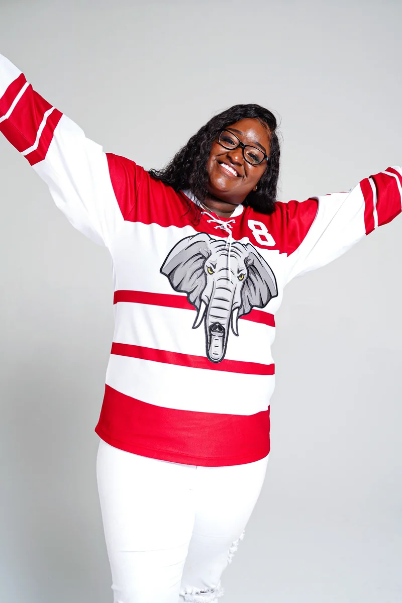 Red and white sports hockey jersey with giant elephant chest patch worn by model
