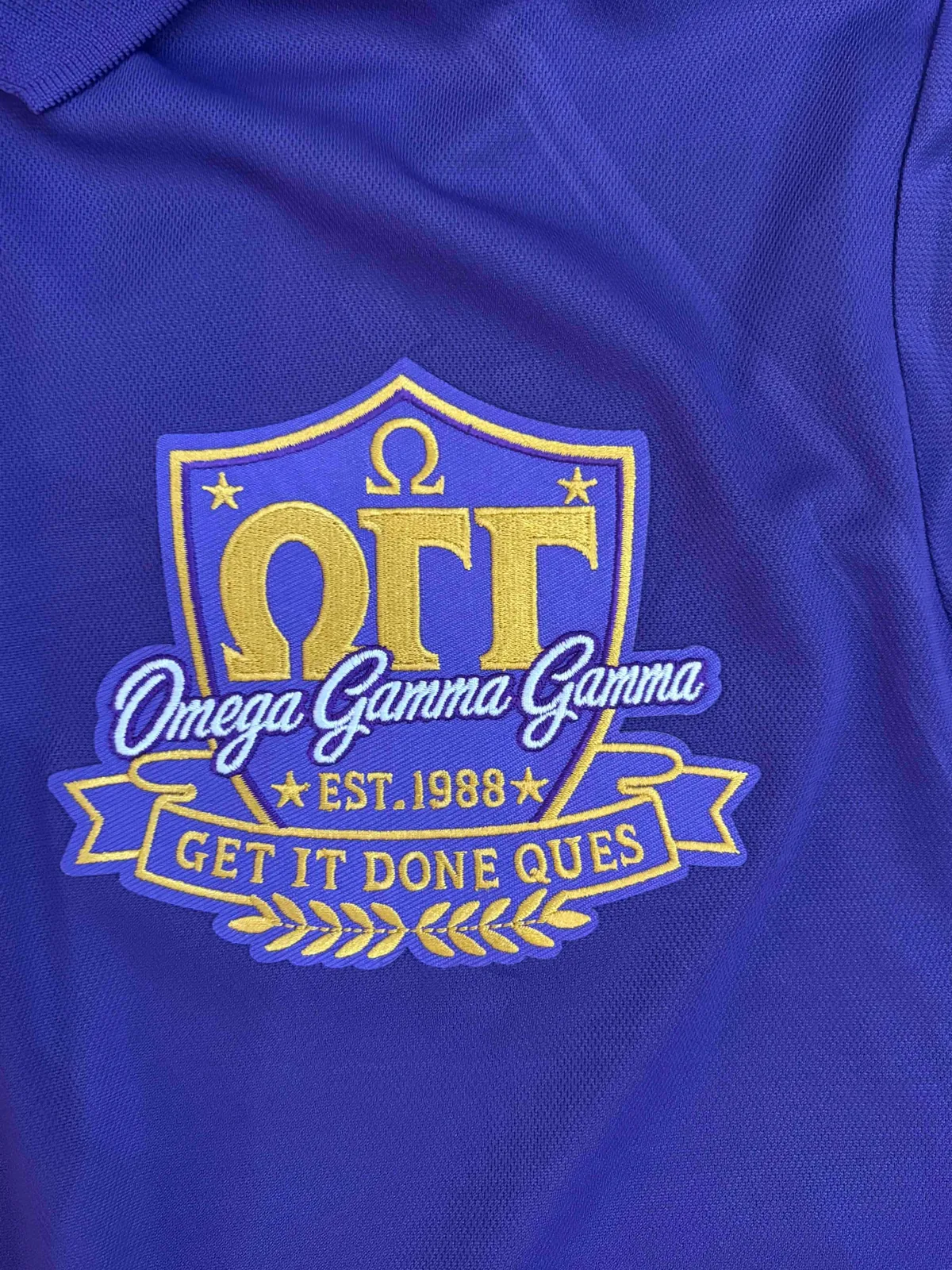 Embroidered emblem on a blue polo shirt