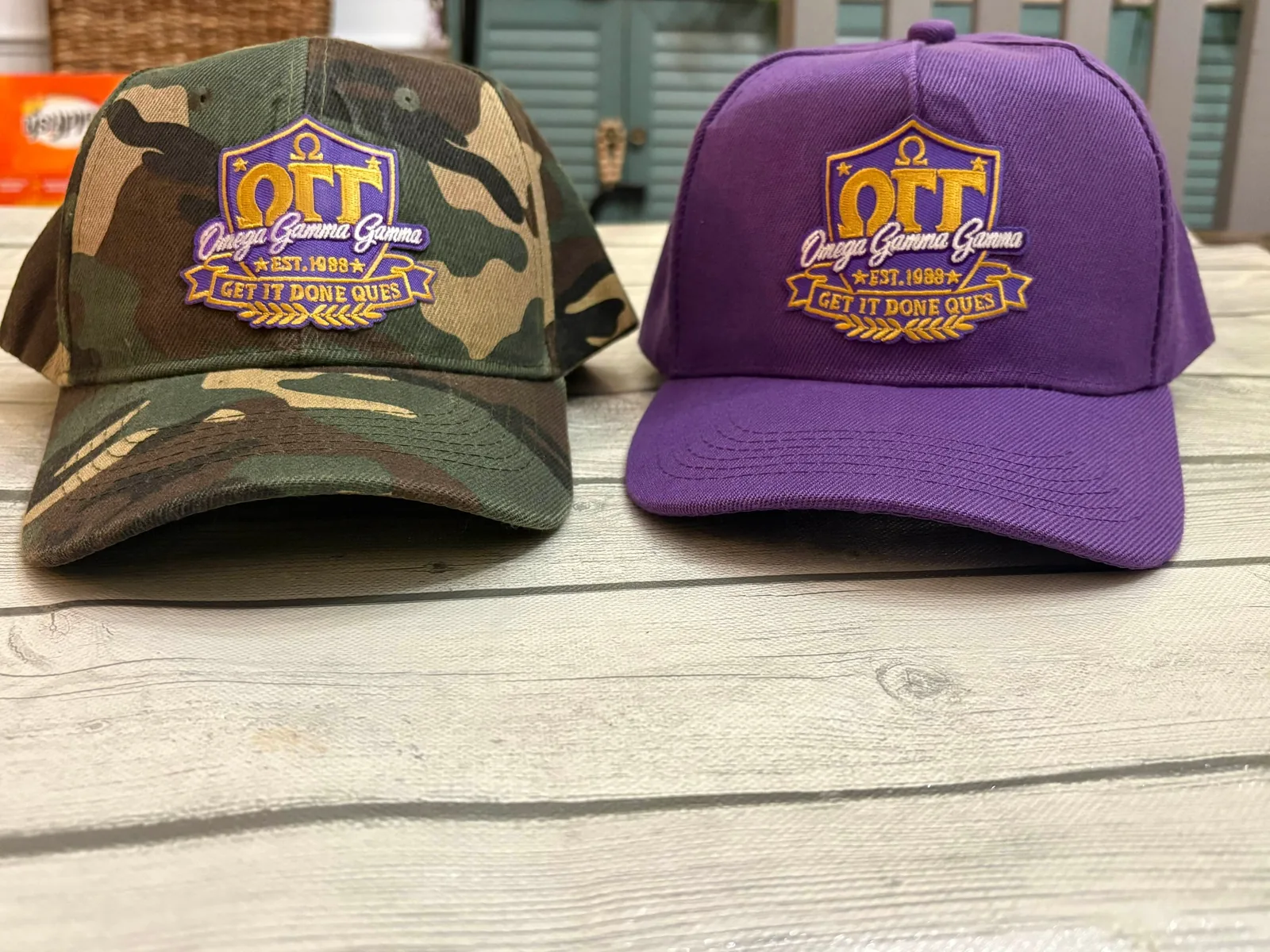 Two caps embroidered with the same emblem